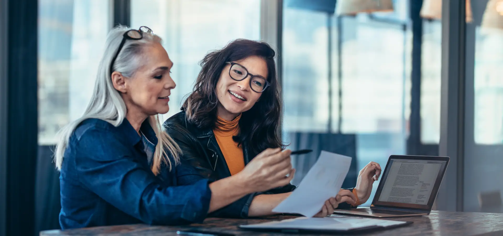 Seasoned female executive meeting with a younger female executive